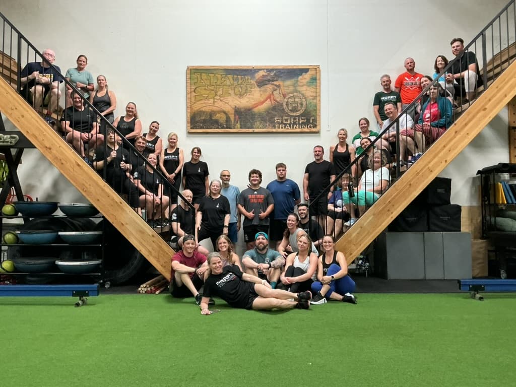 ADAPT staff and members gathered on the iconic A-frame staircase