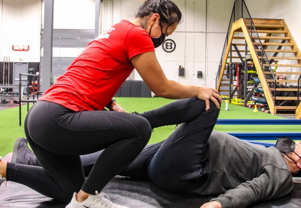 ADAPT clinician guiding a member through a hip mobility exercise