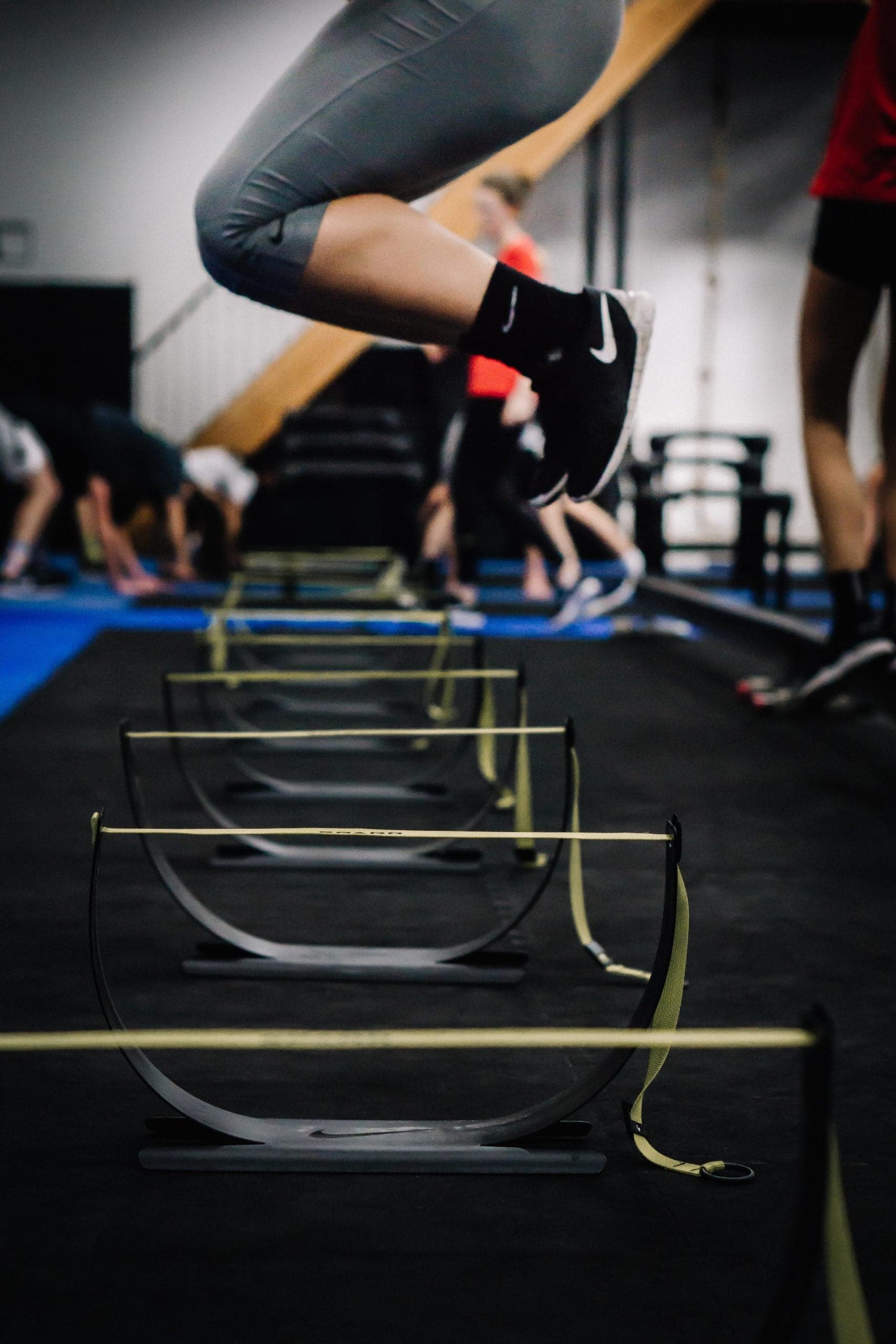 Youth athlete clearing hurdles: explosive performance training at ADAPT