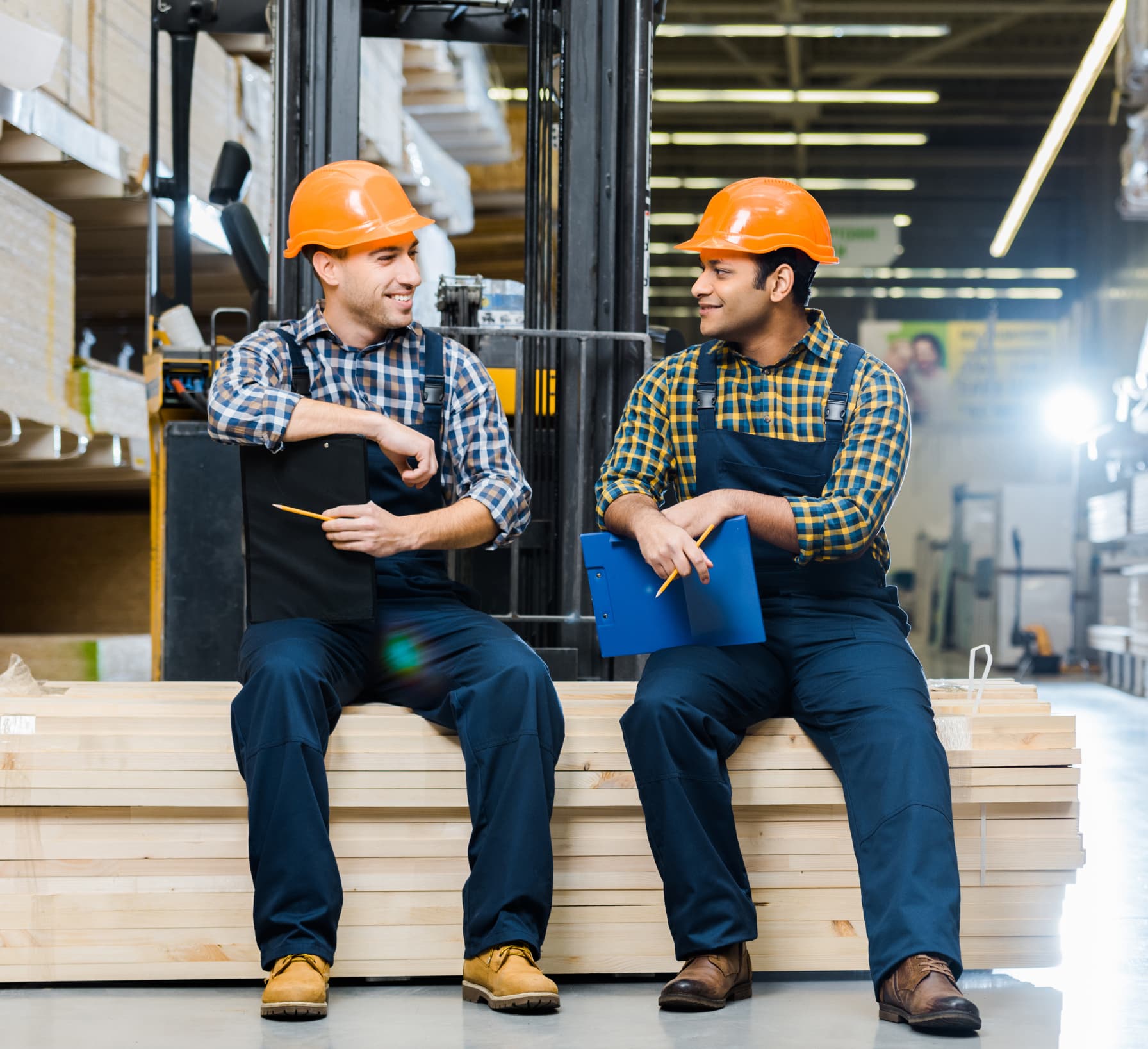 Two industrial workers in safety gear talking on the job. The durability culture ADAPT helps build